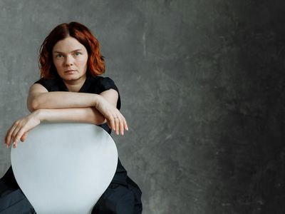 Person doing a seated forward fold pose